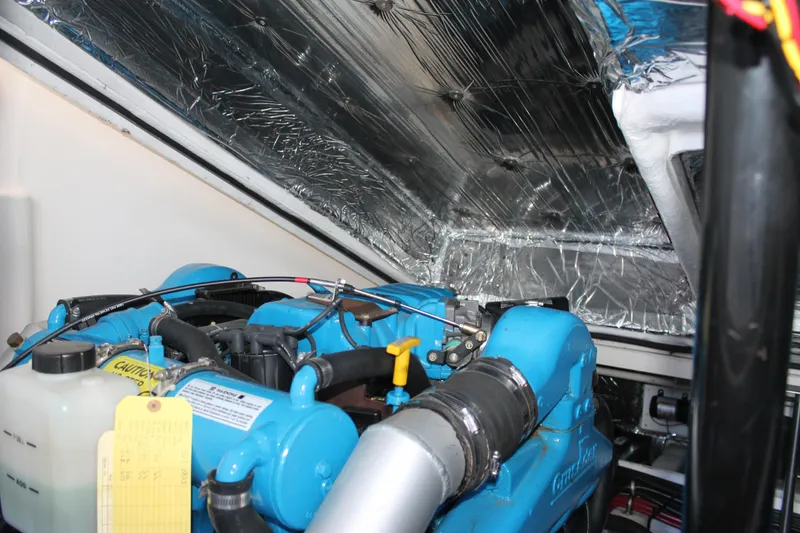 Slide: The Image of Engine compartment of a 1998 Tiara Yachts 2900 Coronet, featuring a blue engine. - 28
