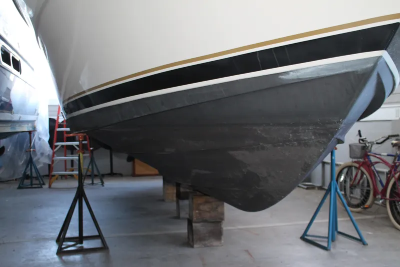 Slide: The Image of 1998 Tiara Yachts 2900 Coronet in storage, supported by stands in a garage. - 4