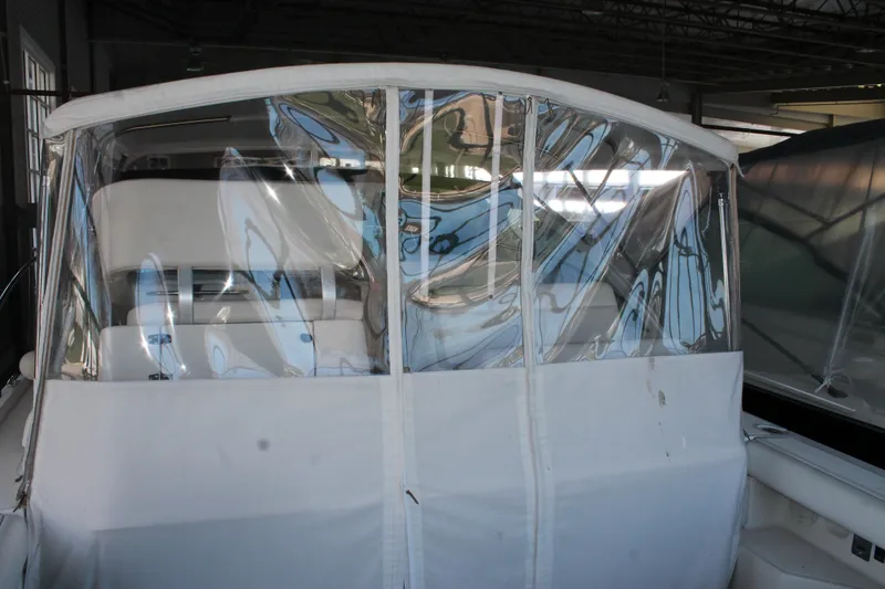 Slide: The Image of 1998 Tiara Yachts 2900 Coronet with clear protective cover in a storage facility. - 6