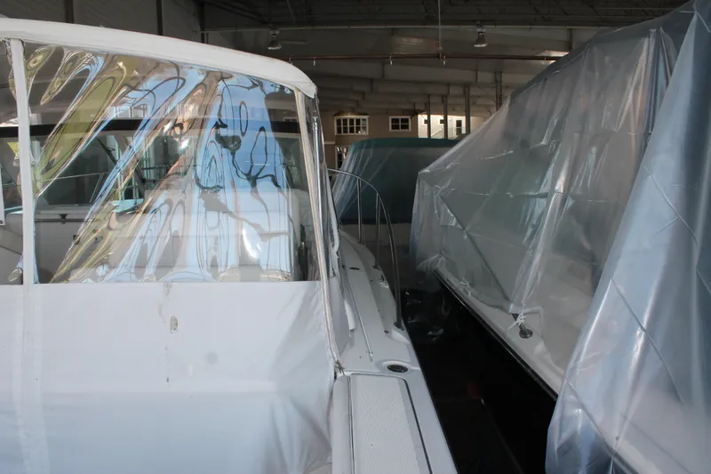 Slide: The Image of 1998 Tiara Yachts 2900 Coronet stored indoors, partially covered with protective plastic. - 7