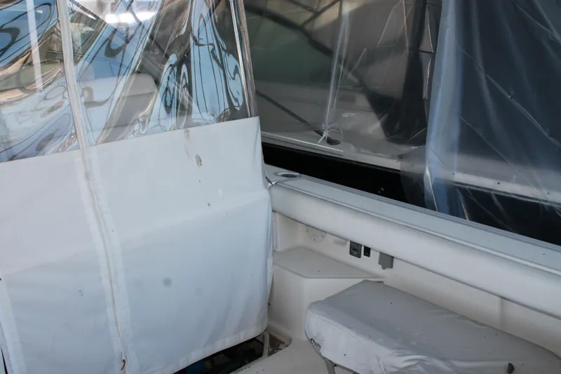 Slide: The Image of 1998 Tiara Yachts 2900 Coronet interior with protective covers and seating area. - 8