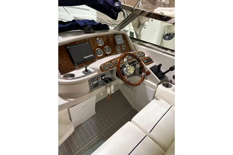 Slide: The Image of 2004 Formula 400 Super Sport boat cockpit with wood accents and Raymarine navigation system. - 10