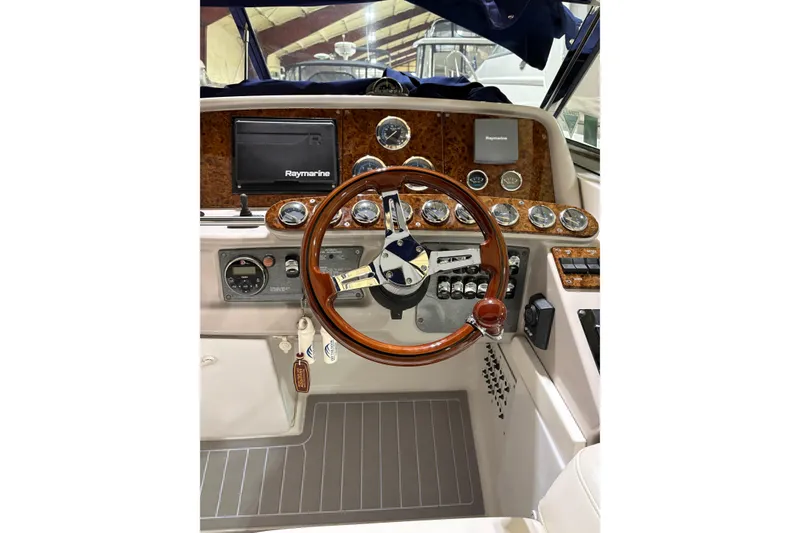Slide: The Image of 2004 Formula 400 Super Sport boat dashboard with wood accents and Raymarine equipment. - 11