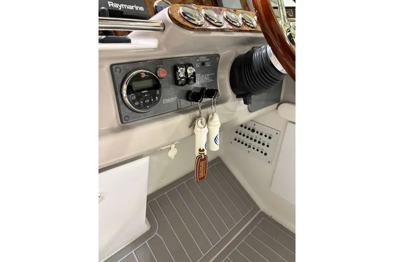 Slide: The Image of 2004 Formula 400 Super Sport dashboard with Raymarine equipment and keychains. - 13