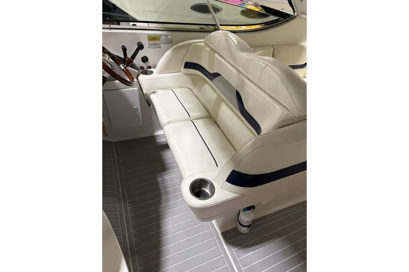 Slide: The Image of 2004 Formula 400 Super Sport boat interior with white seating and cup holders. - 17
