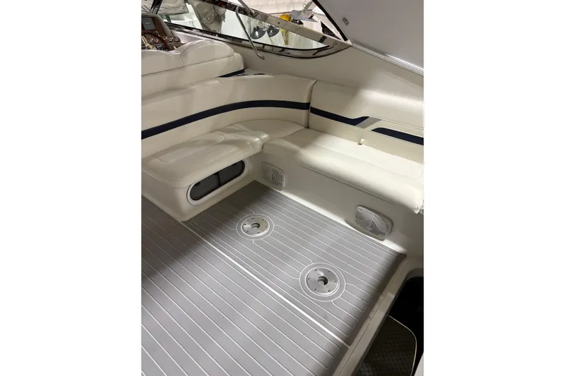 Slide: The Image of 2004 Formula 400 Super Sport boat interior with white seating and sleek design. - 19