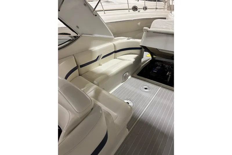 Slide: The Image of 2004 Formula 400 Super Sport boat interior with white seating and open engine compartment. - 20