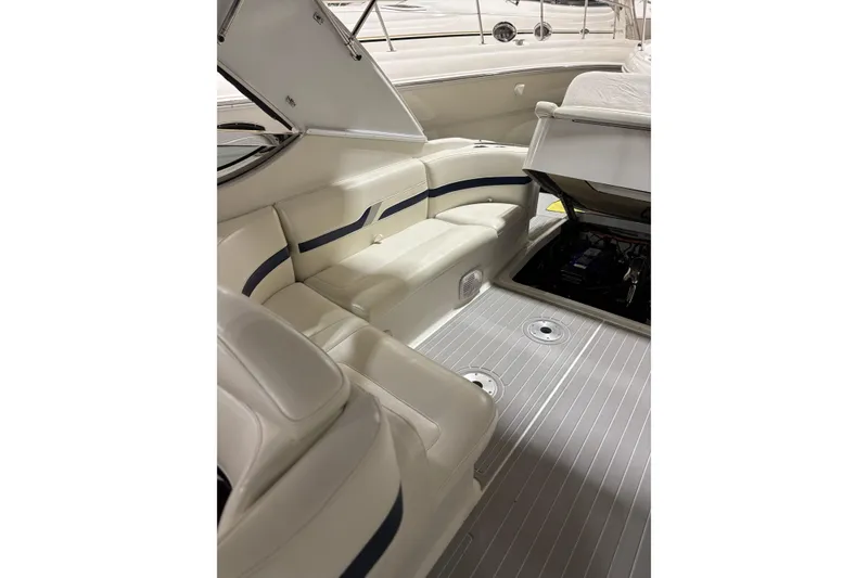 Slide: The Image of 2004 Formula 400 Super Sport boat interior with white seating and open engine compartment. - 21