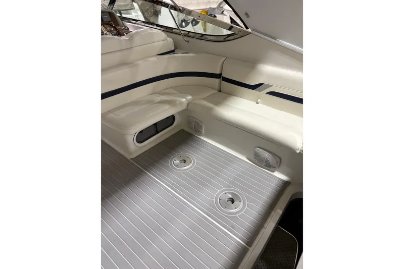 Slide: The Image of Interior of 2004 Formula 400 Super Sport boat with white seating and gray flooring. - 22
