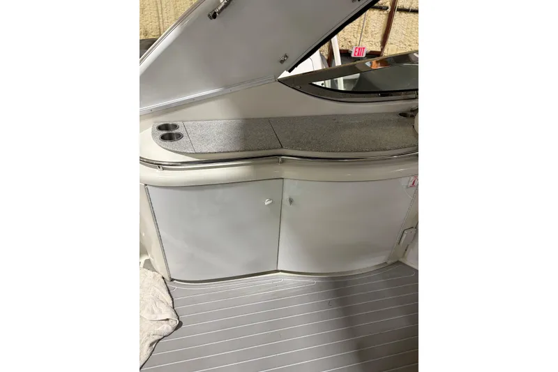 Slide: The Image of 2004 Formula 400 Super Sport boat interior with storage cabinets and countertop. - 23