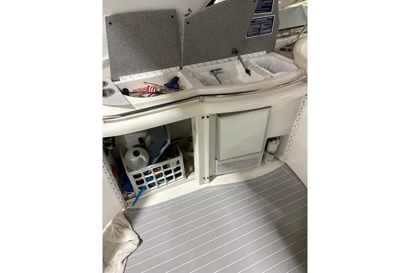 Slide: The Image of 2004 Formula 400 Super Sport boat interior with open storage compartments and sink. - 24