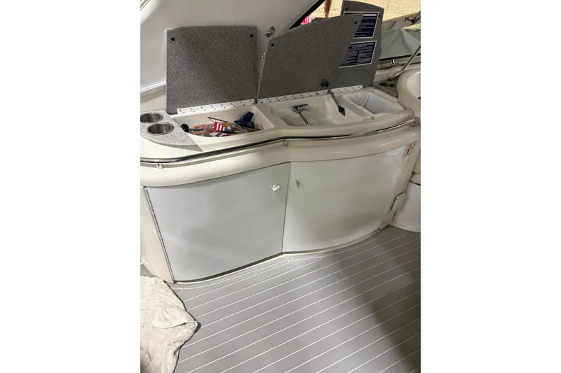 Slide: The Image of 2004 Formula 400 Super Sport boat interior with open storage compartment and cup holders. - 25