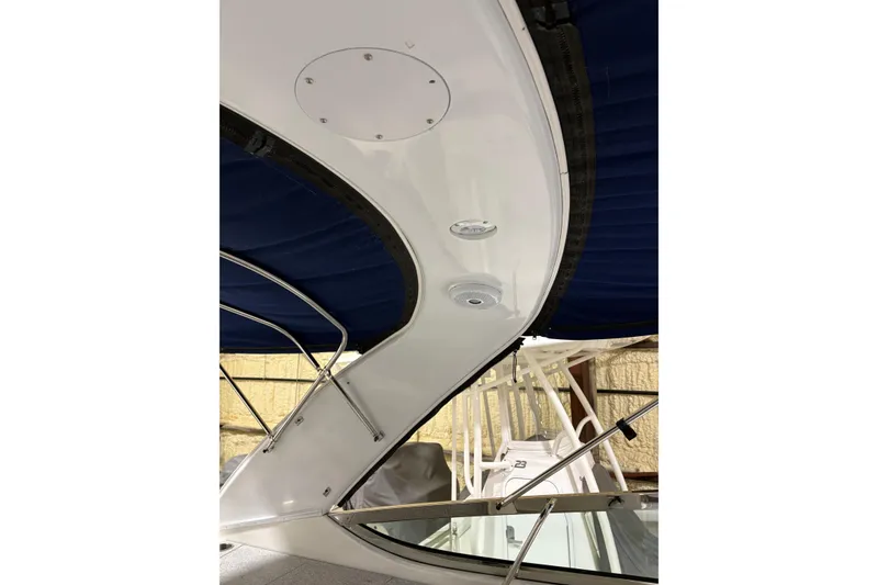 Slide: The Image of 2004 Formula 400 Super Sport boat interior with blue canopy and sleek white design. - 26