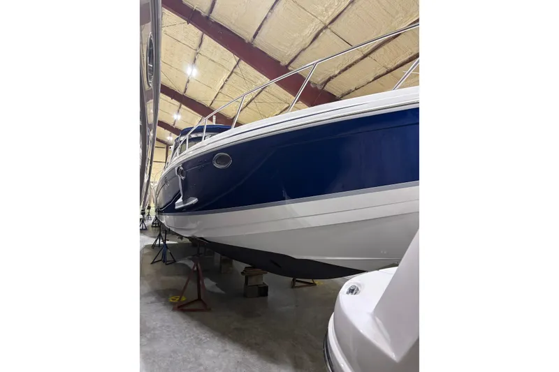 Slide: The Image of 2004 Formula 400 Super Sport boat in storage, showcasing sleek blue and white hull design. - 3