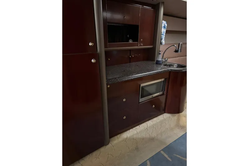 Slide: The Image of Interior of 2004 Formula 400 Super Sport yacht with kitchenette, microwave, and sink. - 30