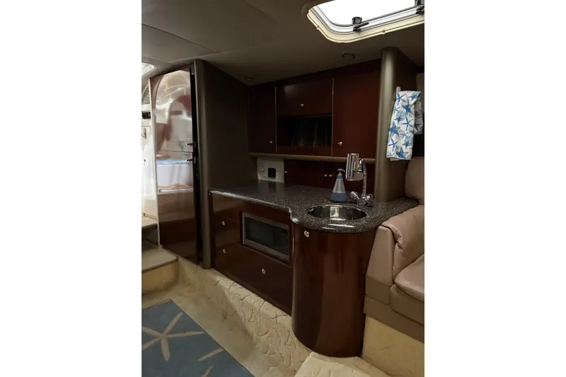 Slide: The Image of Interior of 2004 Formula 400 Super Sport yacht with kitchenette and seating area. - 31