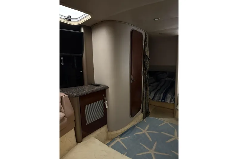 Slide: The Image of Interior of a 2004 Formula 400 Super Sport boat with cozy cabin and modern amenities. - 33