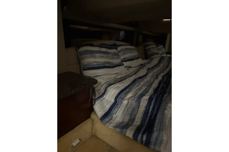 Slide: The Image of Interior cabin of 2004 Formula 400 Super Sport with striped bedding. - 37