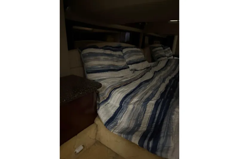 Slide: The Image of Interior cabin of 2004 Formula 400 Super Sport with striped bedding. - 38
