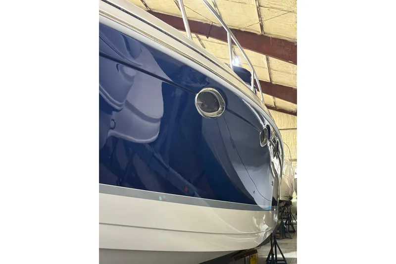 Slide: The Image of 2004 Formula 400 Super Sport boat with sleek blue and white hull in storage. - 4