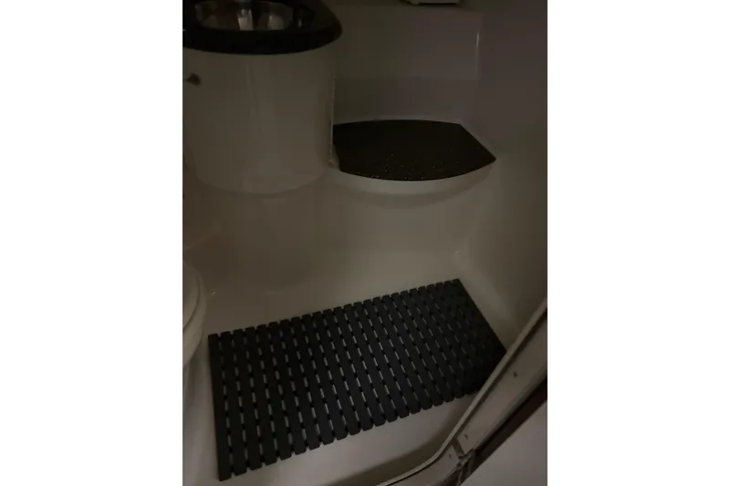 Slide: The Image of Interior of 2004 Formula 400 Super Sport boat bathroom with dark mat and sink. - 40