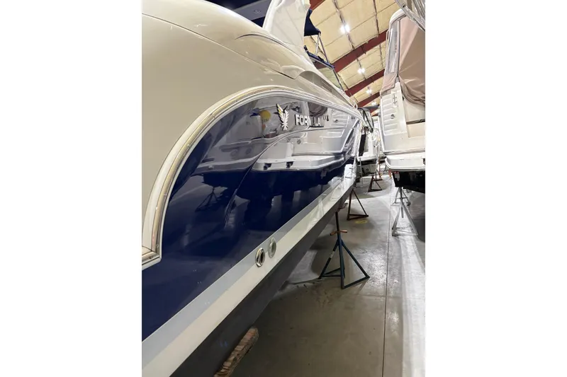 Slide: The Image of 2004 Formula 400 Super Sport boat in storage, showcasing sleek design and blue hull. - 5