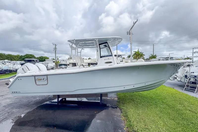 The Image of 2026 Sea Hunt Gamefish 30 boat displayed on grass. - 1