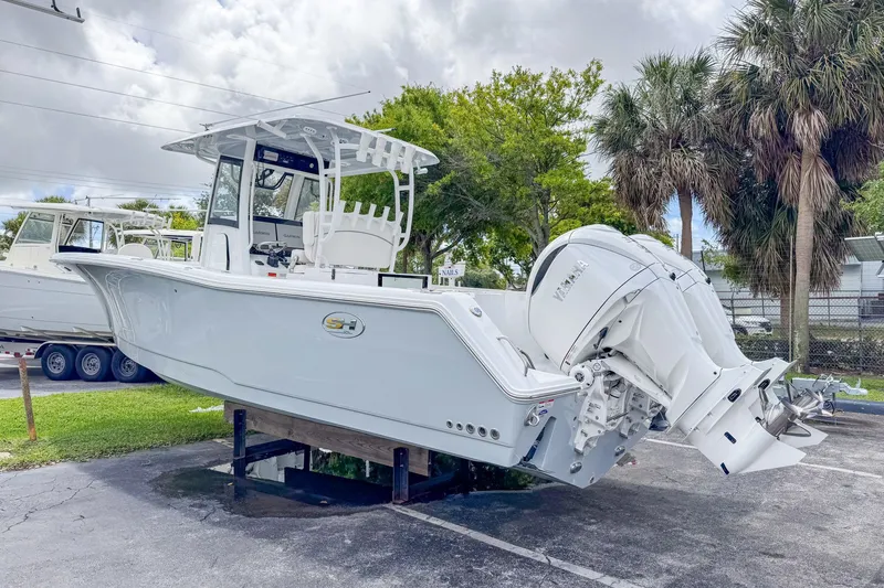Slide: The Image of Sea Hunt Gamefish 30 boat, 2026 model, parked outdoors. - 5