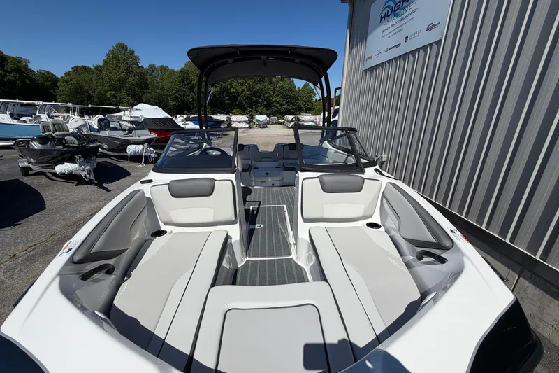 Slide: The Image of 2026 Yamaha Boats AR190 interior with seating, docked outdoors under clear sky. - 13