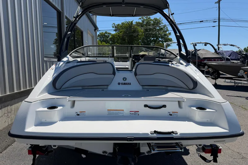 Slide: The Image of 2026 Yamaha Boats AR190, rear view, sleek design, parked outdoors. - 18