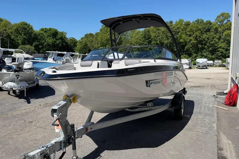Slide: The Image of 2026 Yamaha Boats AR190 on trailer, parked outdoors under clear blue sky. - 23