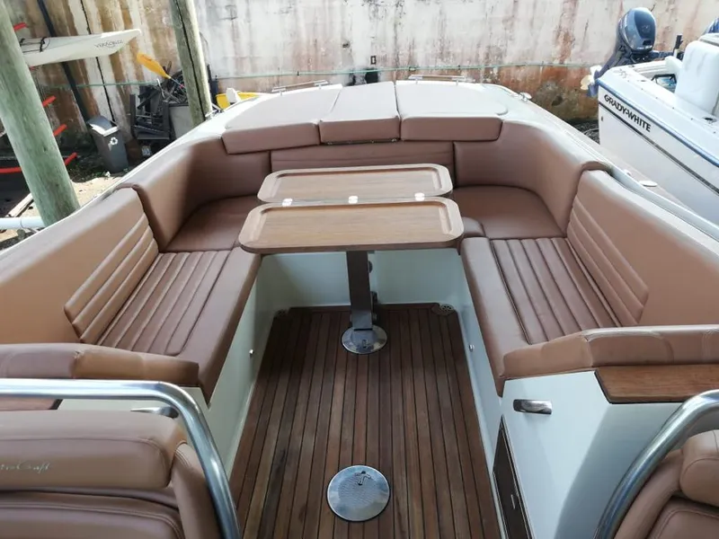Slide: The Image of Interior of a 2014 Chris-Craft Launch 32 with brown leather seating. - 10