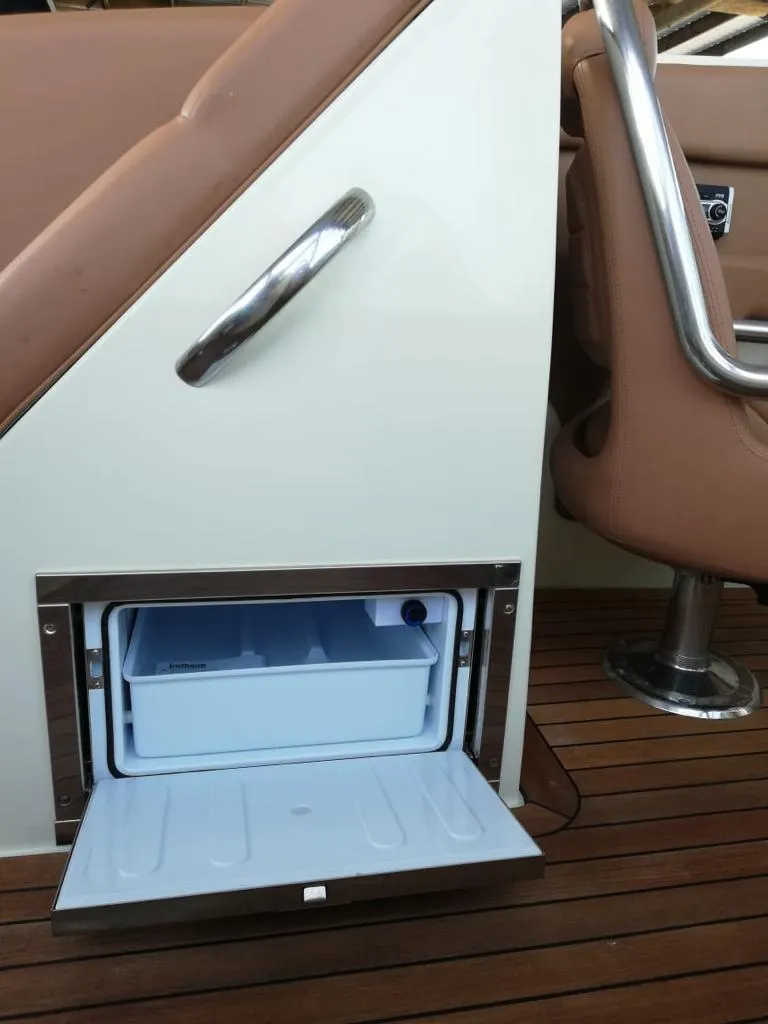 Slide: The Image of Chris-Craft Launch 32 2014, built-in fridge, brown seats, wooden deck. - 15