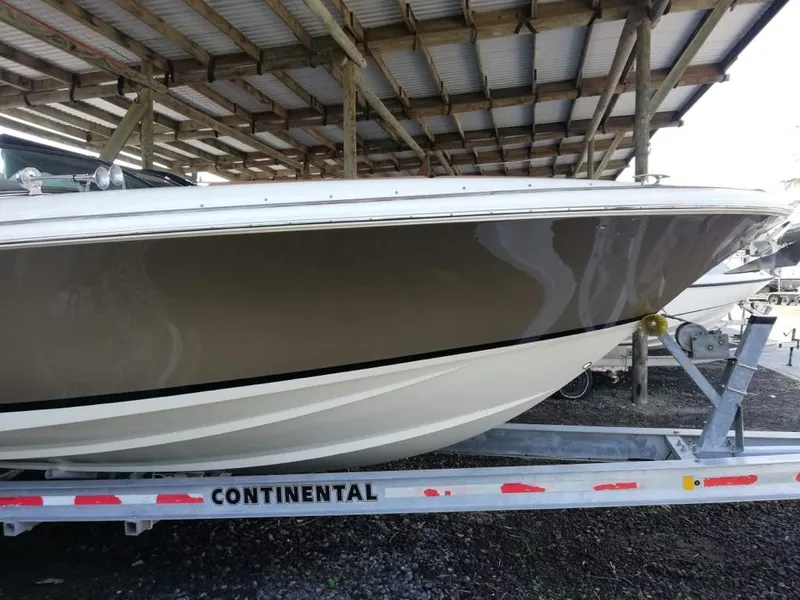 Slide: The Image of 2014 Chris-Craft Launch 32 boat on trailer under shelter. - 2