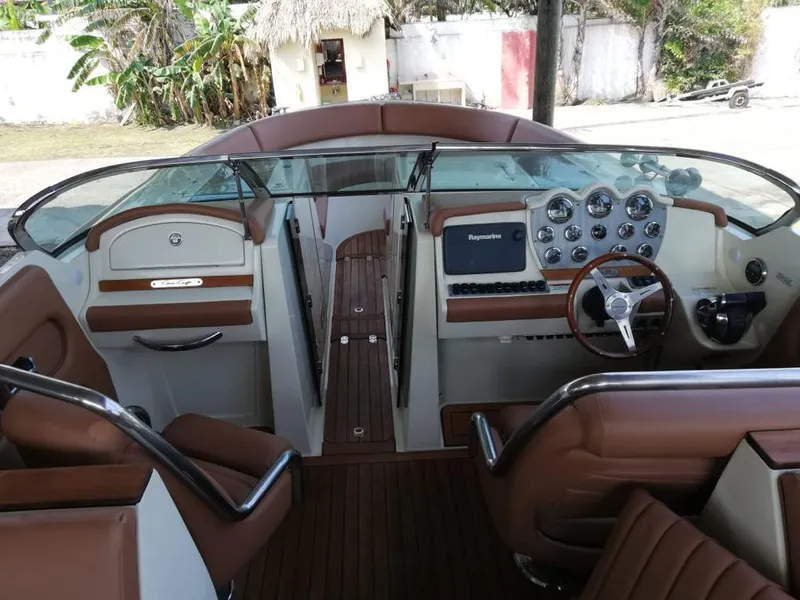 Slide: The Image of Interior view of a 2014 Chris-Craft Launch 32 boat with brown leather seating. - 5