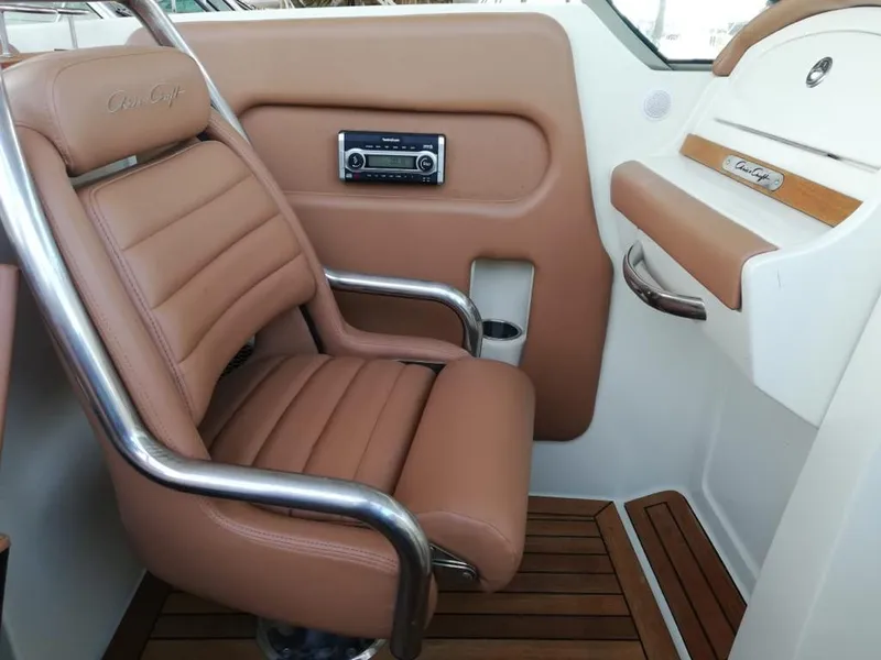 Slide: The Image of Interior of a 2014 Chris-Craft Launch 32 with leather seat and wood accents. - 8