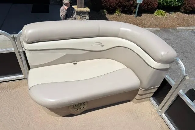 Slide: The Image of Bennington 20SLi 2010 boat seat with beige upholstery and curved design. - 10