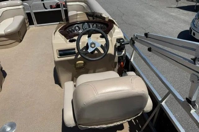 Slide: The Image of 2010 Bennington 20SLi boat interior with steering console and seating. - 14
