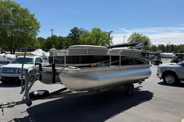 Slide: The Image of 2010 Bennington 20SLi pontoon boat on trailer in parking lot, surrounded by vehicles. - 4