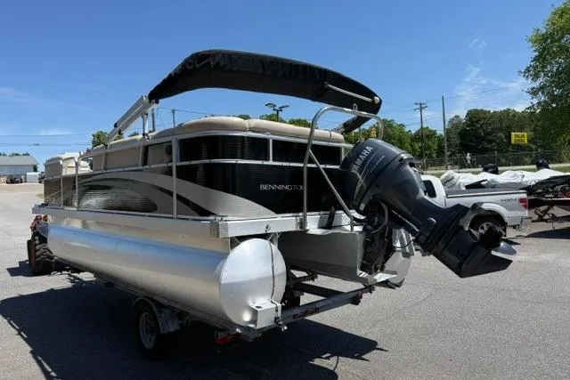 Slide: The Image of 2010 Bennington 20SLi pontoon boat with Yamaha outboard motor on trailer. - 6