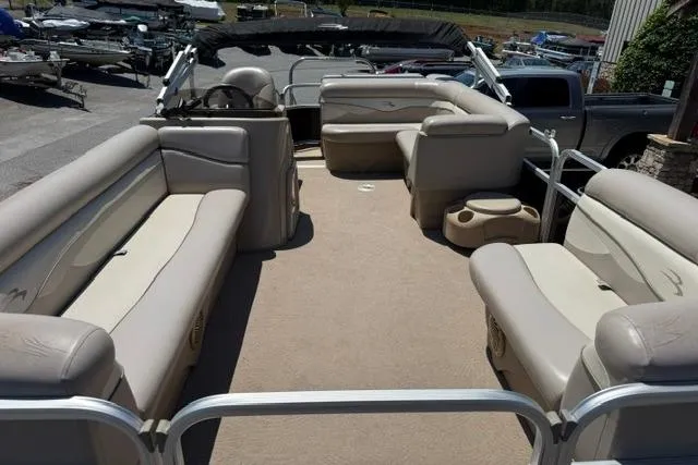 Slide: The Image of 2010 Bennington 20SLi pontoon boat interior with beige seating and spacious layout. - 8