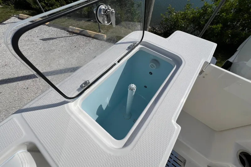 Slide: The Image of Livewell on 2026 Robalo R300 Center Console boat, open lid, white textured surface. - 15