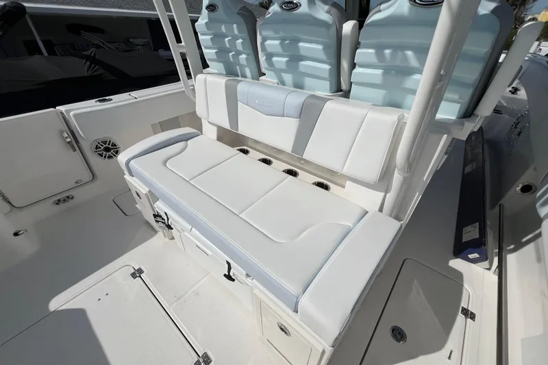 Slide: The Image of 2026 Robalo R300 Center Console boat interior with cushioned seating and storage compartments. - 16