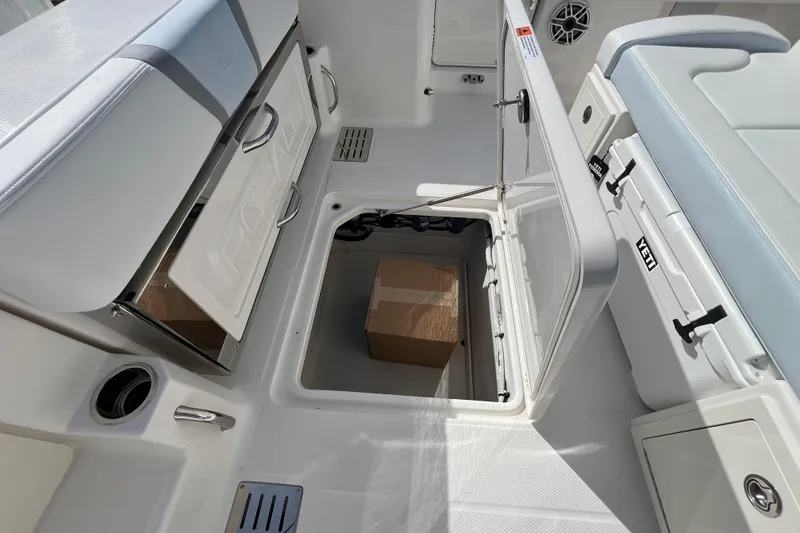 Slide: The Image of 2026 Robalo R300 Center Console boat interior with storage compartments open. - 19