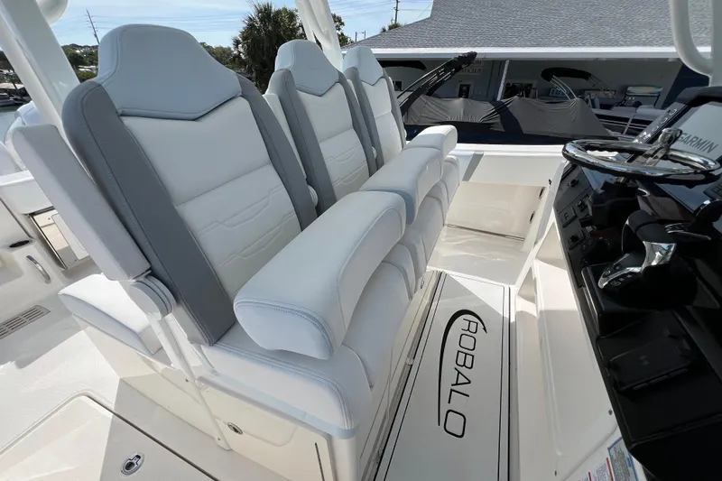 Slide: The Image of 2026 Robalo R300 Center Console boat interior with plush seating and modern helm controls. - 21