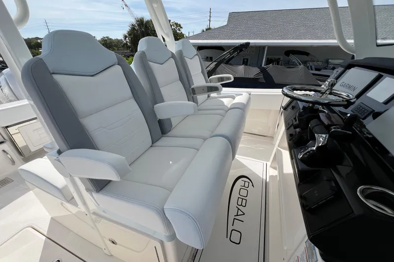 Slide: The Image of 2026 Robalo R300 Center Console boat interior with plush seating and advanced controls. - 22