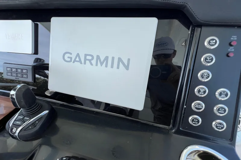 Slide: The Image of 2026 Robalo R300 Center Console dashboard featuring Garmin navigation system and Yamaha controls. - 24