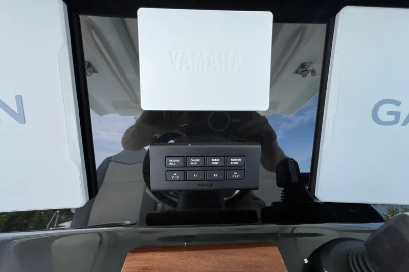 Slide: The Image of 2026 Robalo R300 Center Console dashboard with Yamaha controls and Garmin displays. - 25
