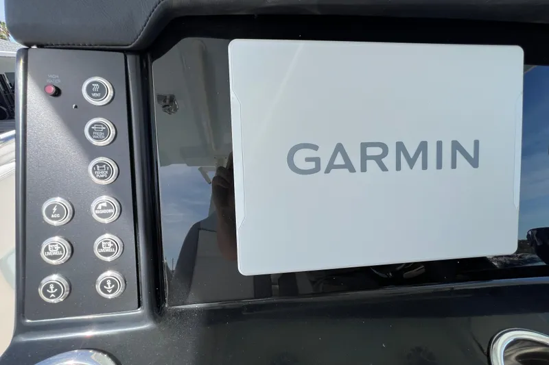 Slide: The Image of 2026 Robalo R300 Center Console dashboard with Garmin navigation system. - 26