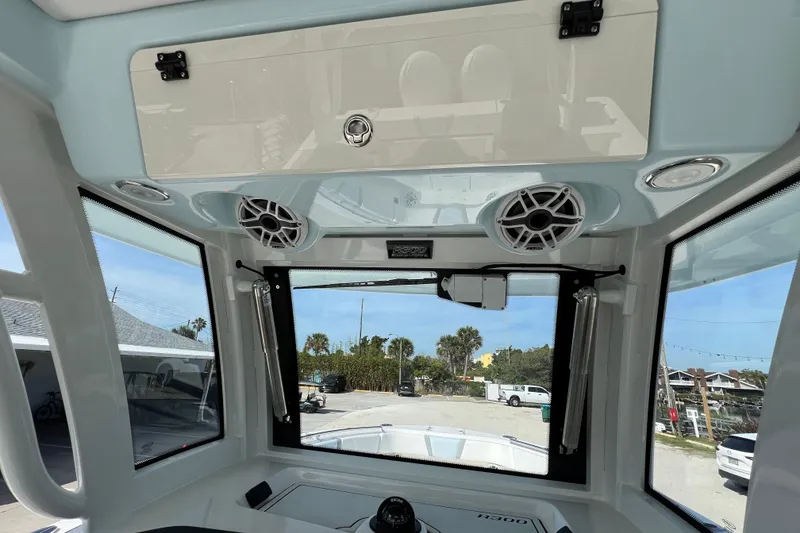 Slide: The Image of 2026 Robalo R300 Center Console boat interior with speakers and storage compartment. - 28